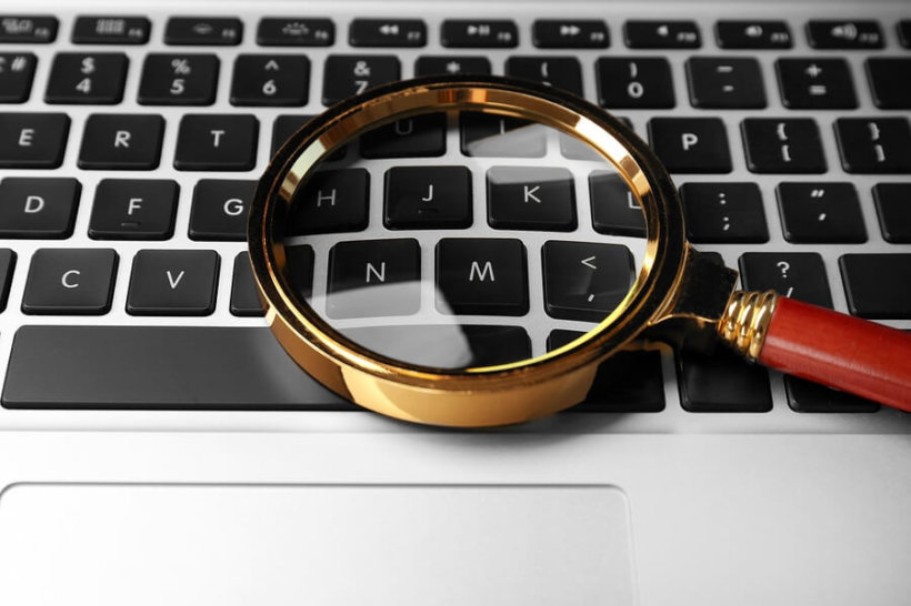 bigstock Magnifying glass on laptop In 205917784